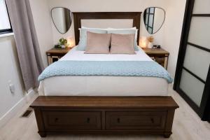 a bedroom with a large bed with two mirrors at Modern Tahoe Retreat in South Lake Tahoe