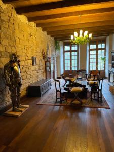 a living room with a table and a statue of a man at Le Château de Sorgues in Cornus