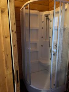 a shower with a glass enclosure in a bathroom at Chalet à Rhodes in Rhodes +15 photos
