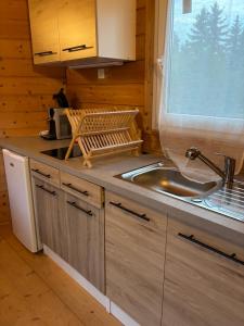 a kitchen with a sink and a window in a cabin at Chalet à Rhodes in Rhodes