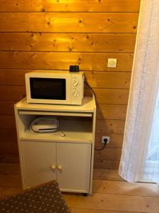 a microwave on top of a table in a room at Chalet à Rhodes in Rhodes