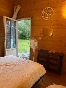 a bedroom with a bed and a clock on the wall at Chalet à Rhodes in Rhodes