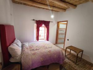 a bedroom with a pink bed and a window at Riad tinghir in Tinerhir +12 photos