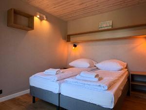 a bedroom with two beds with white sheets and pillows at Marina Górkło - Żurawi Kąt in Górkło +28 photos