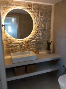 a bathroom with a sink and a mirror at Liodentro House in Karpathos