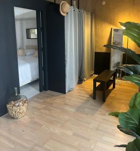 a room with a bedroom with a bed and a table at L écrin du Luberon in Cadenet