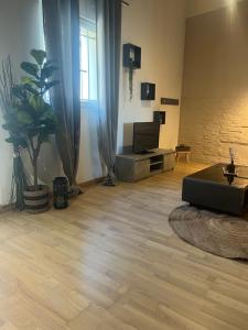 a living room with a couch and a wooden floor at L écrin du Luberon in Cadenet