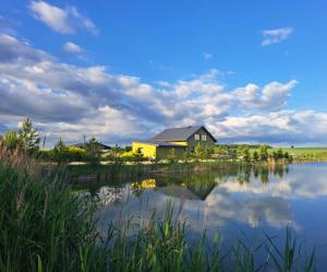 a house on the shore of a lake at Villa reed in Dasiūnai