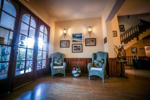 a living room with two chairs and a staircase at Castellu Rossu in Lucciana