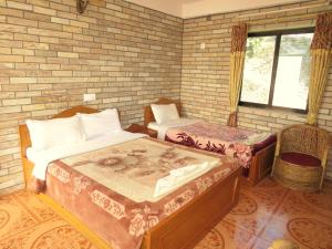 A bed or beds in a room at Lake Vision Guesthouse