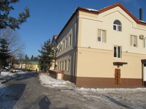 a large building with snow on the side of it at Mini-hotel Na Pidgradskiy in Uzhhorod
