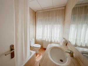 a bathroom with a sink and a toilet at Hostal Bertran in Salás de Pallás +67 photos