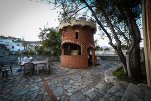 a small brick tower with a table and chairs at Castellu Rossu in Lucciana