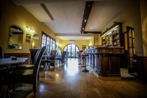 a restaurant with a bar and tables and chairs at Castellu Rossu in Lucciana