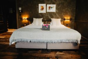 a bedroom with a large bed with a box on it at Hôtel Le Sanglier des Ardennes in Durbuy +58 photos