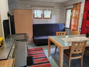 a living room with a table and a couch at Metsämökki in Lohja