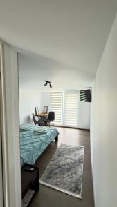 a bedroom with a bed and a table in it at Vraja din deal in Domneşti