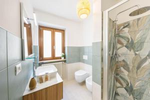 a bathroom with a toilet sink and a shower at Domio - Residenza del Corso in Atri