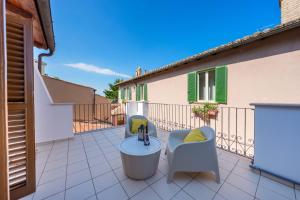 a balcony with a chair and a faucet at Domio - Residenza del Corso in Atri