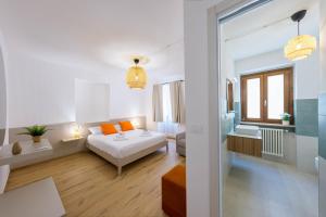 a bedroom with a bed and a living room at Domio - Residenza del Corso in Atri