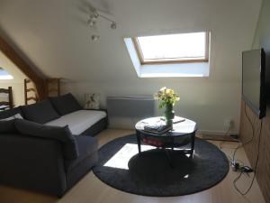 a living room with a couch and a table at L'auberge d'authie in Authie