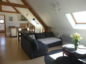 a living room with a couch and a table at L'auberge d'authie in Authie