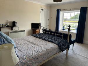 a bedroom with a bed and a window at Saint Quintin Hotel in Harpham