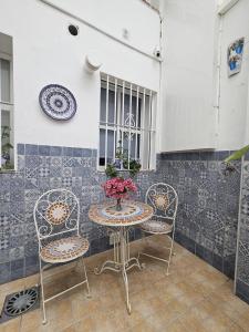 a table and chairs with a vase of flowers at Puertas de la Catedral in Córdoba +62 photos
