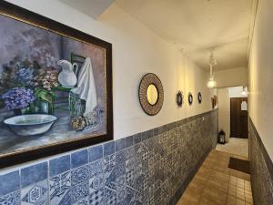 a hallway with a painting of vases on the wall at Puertas de la Catedral in Córdoba