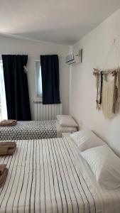 a bedroom with two beds with blue curtains at Trulli bella vite in Putignano +40 photos