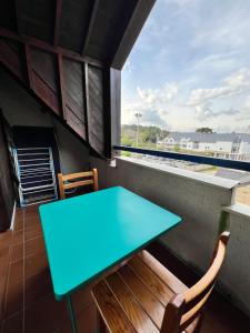 a blue table and chairs on a balcony with a view at T1 bis 200m du port in La Trinité-sur-Mer