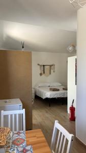 a room with a bed and a table and chairs at Trulli bella vite in Putignano