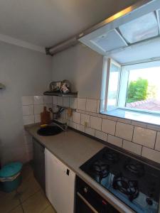 a kitchen with a stove and a window in it at Casa di Rose in Vrsar
