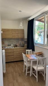 a kitchen with a table and chairs and a window at Trulli bella vite in Putignano