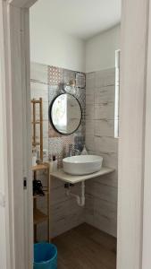 a bathroom with a sink and a mirror at Trulli bella vite in Putignano