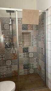 a bathroom with a shower with a toilet at Trulli bella vite in Putignano
