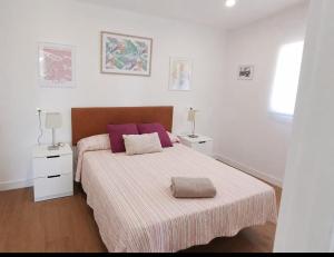 a bedroom with two beds with purple pillows at La Casona de Carcedo 3 in OVD