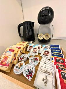 a table with some food and a coffee maker at The Six Ortigia Residences in Syracuse