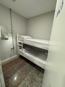 a small room with two bunk beds in it at Comfort Zone in Porto Alegre