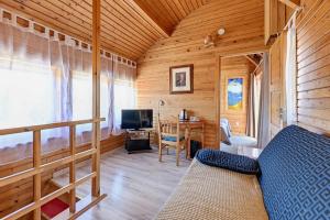 a room with a bed and a desk and a television at Päeva Villa in Haapsalu