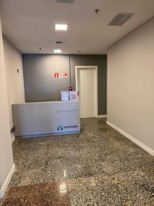 an empty office with a reception desk in a room at Comfort Zone in Porto Alegre