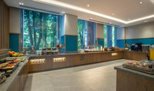 a buffet line in a hotel with trees in the windows at Maldron Hotel Croke Park in Dublin