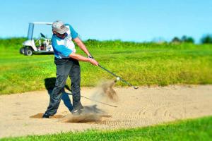 a man hitting a golf ball with a club at Toten Hotel Sillongen in Eklund