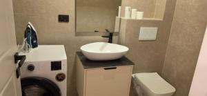 a bathroom with a sink and a washing machine at Villa Castro in Ulcinj +17 photos