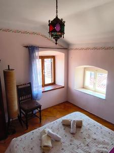 a bedroom with a bed and a chair and windows at Casa di Rose in Vrsar