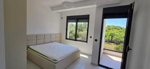a small bedroom with a bed and a window at Villa Castro in Ulcinj