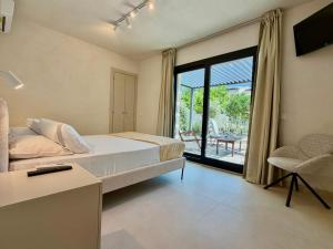 a bedroom with a bed and a sliding glass door at La Rosa dei Templi in Agrigento