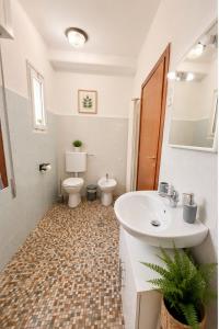 a bathroom with a sink and a toilet at Sunflower Apartment in Dogna +1 photo