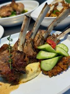 a plate of food with meat and vegetables on a table at Soilsmart Haven in Abuja