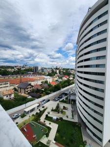 a view of a city with a tall building at Luxury apartment Avanera in Suceava